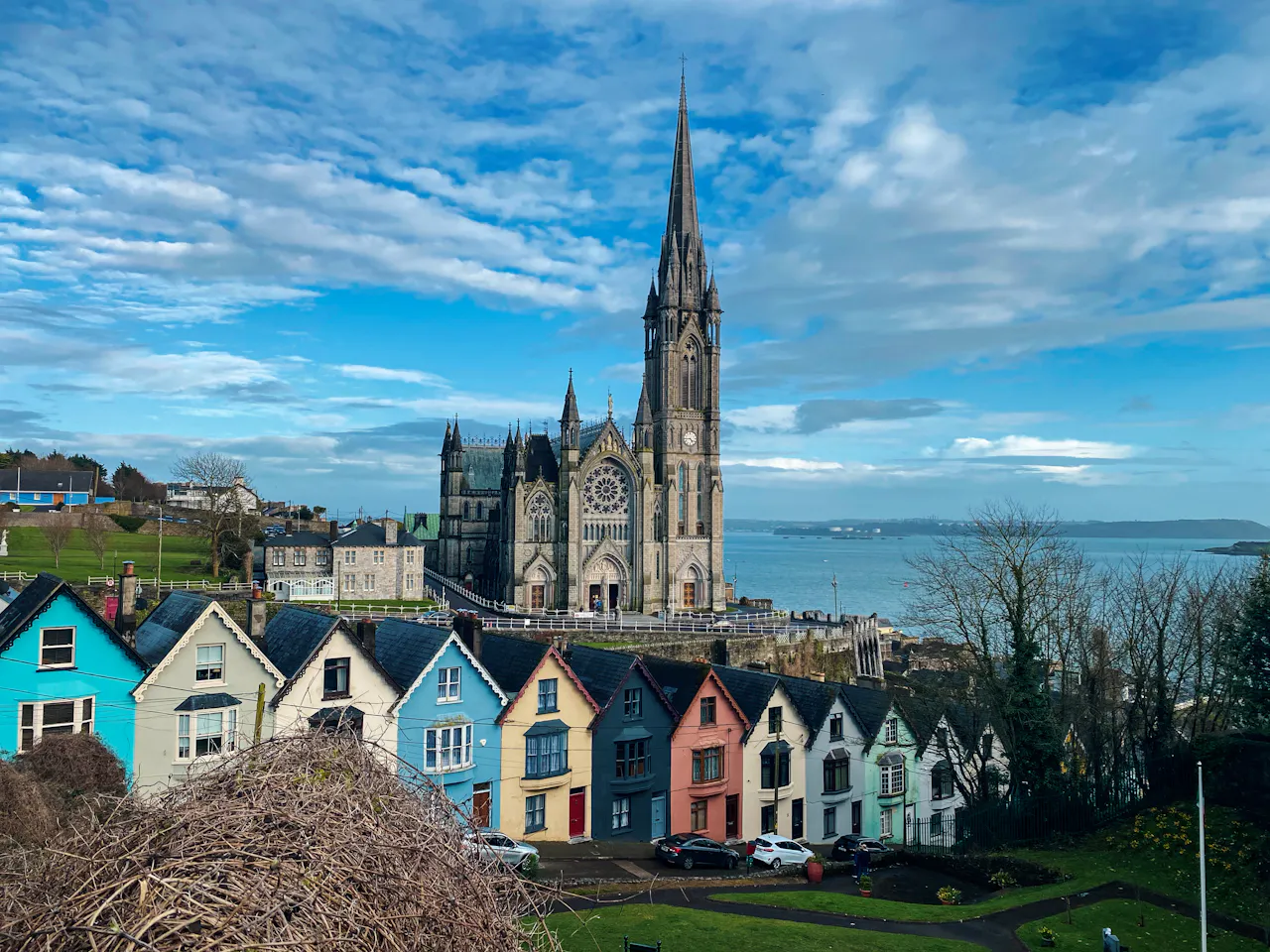 Colourful houses below a cathedral in Cobh, Ireland
