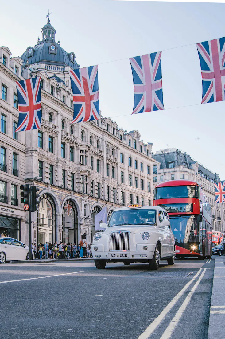 A London street with Union Jack bunting and a red bus